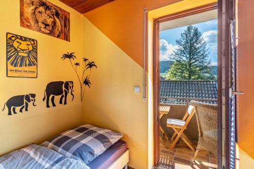 a small room with a bed and a balcony at Hirschturmblick in Zell am Harmersbach