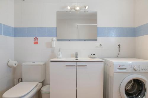 a bathroom with a washing machine and a washer at Casa Rocio in Barrio Nuevo
