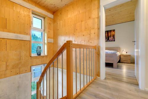 a wooden staircase in a room with a bedroom at Ferienhäuser Stickel in Freudenstadt