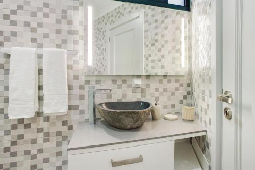 a bathroom with a bowl sink on a counter at Alegria Dream Home in Funchal
