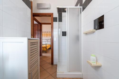 a bathroom with a walk in shower and a sink at Maya in Villasimius