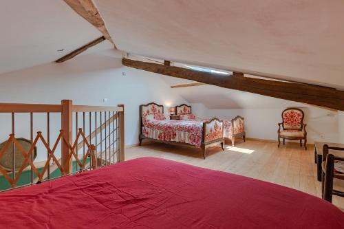 a bedroom with two beds in a attic at L'Arche aux Peyruches in Assieu