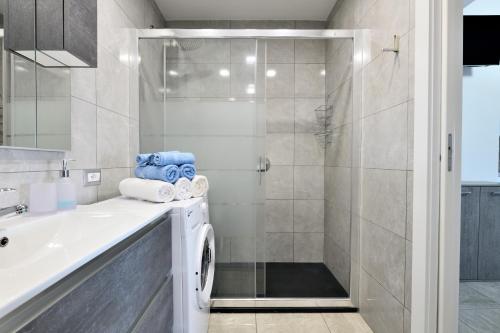 a bathroom with a sink and a shower at Pasquale Home Holiday in Bari Sardo