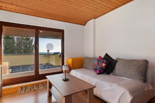 a living room with a couch and a table at Ferienwohnung Schöne Aussicht in Gemmrigheim