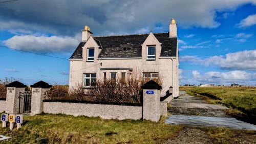 an old house sitting on the side of a road at Tigh Stobbian in Lionel
