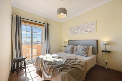 a bedroom with a bed and a large window at My Friendly House in Lagos