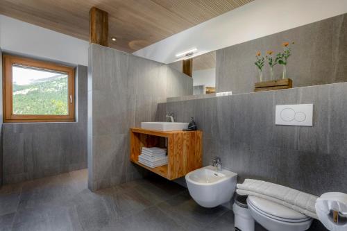 a bathroom with a sink and a toilet at Vernalhof Apt Panorama in Sluderno