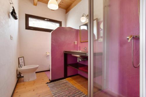 a pink bathroom with a sink and a shower at Tayu Eco Villa in Villaverde