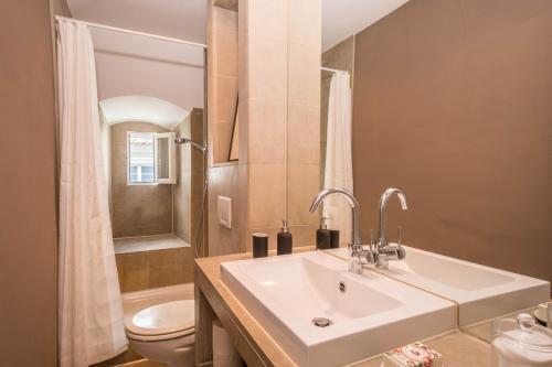 a white bathroom with a sink and a toilet at Schloss Kirchberg - Rose in Immenstaad am Bodensee