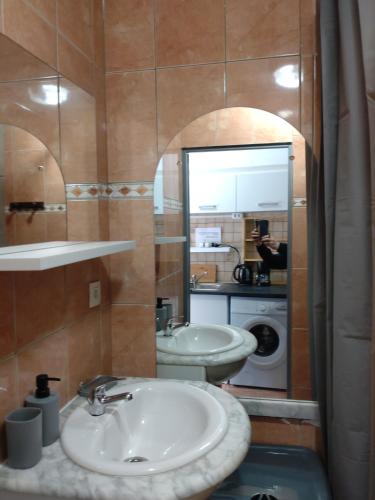 a bathroom with two sinks and a mirror at La Clef in Saint-Julien-Molin-Molette