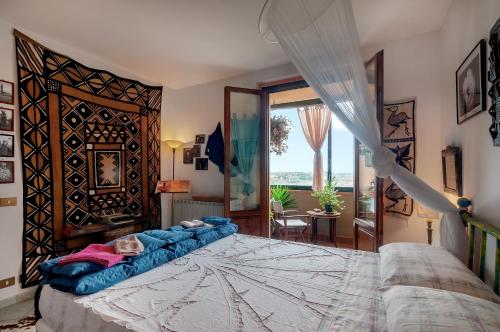 a bedroom with a large bed and a large window at Casa Bice in Marcialla