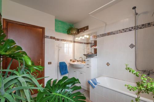 a white bathroom with a tub and a sink at Casa Bice in Marcialla