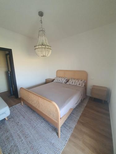 a bedroom with a bed and a chandelier at Civico 316 con Piscina in Porto Recanati