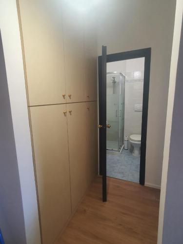 a room with a mirror and a bathroom with a toilet at Civico 316 con Piscina in Porto Recanati