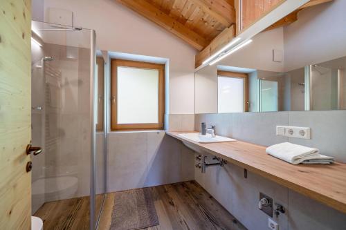 a bathroom with a sink and a shower at Matscherhof Ferienwohnung Helena in Santa Valpurga