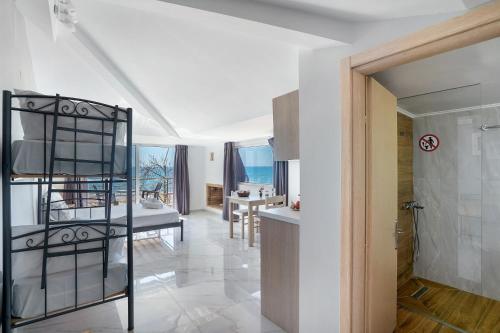 a kitchen and living room with a spiral staircase in a house at Iguana studio 18 in Preveza
