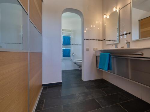 a bathroom with a sink and a toilet and a mirror at Fustera in Benissa
