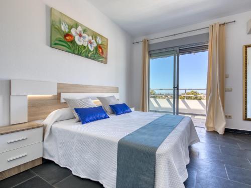 a bedroom with a bed and a large window at Fustera in Benissa