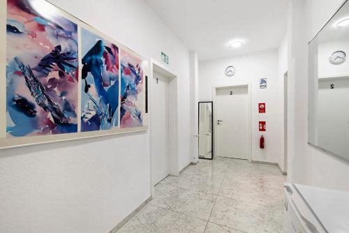 a hallway of an art gallery with paintings on the walls at Haus Rosa in Albstadt