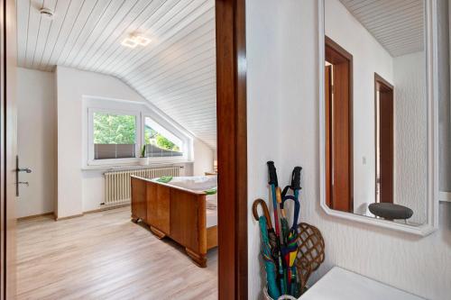a room with a sink and a desk with a window at Ferienwohnung Haus Waldfee in Sulzburg