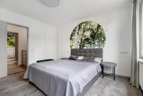a bedroom with a large bed and a window at Apartment am Wald in Dörentrup