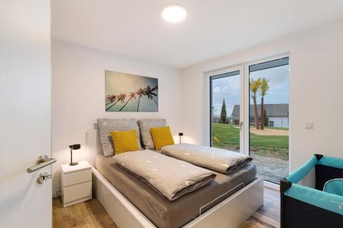 a bedroom with a bed with yellow pillows at Relax Oase in Sasbachwalden