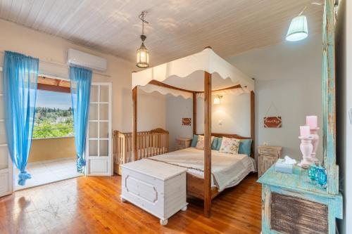 a bedroom with a canopy bed and a fireplace at Blue apartment Corfu in Perivólion
