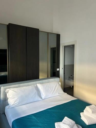 a bedroom with a large bed with towels on it at Luxury Room in Bari