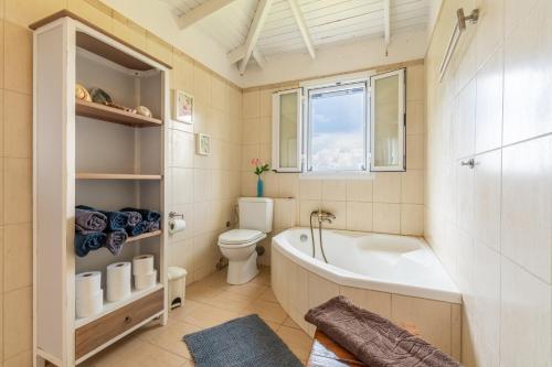 a bathroom with a tub and a toilet and a sink at Blue apartment Corfu in Perivólion