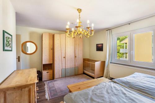 a bedroom with a bed and a chandelier at Ferienwohnung Schlossbergblick in Arnsberg