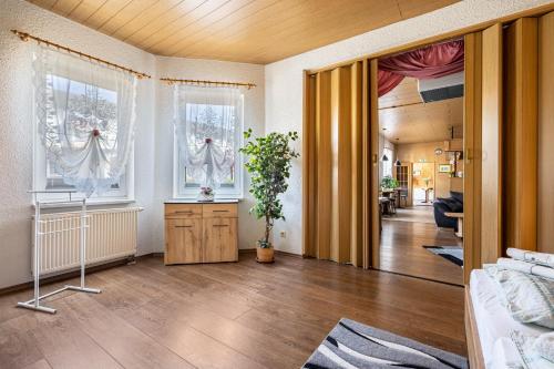a living room with two windows and a door at Ferienhaus Nestwärme in Calau