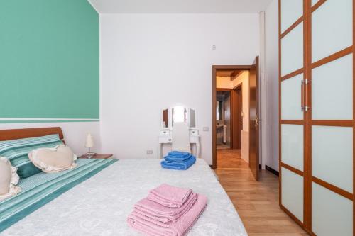 a bedroom with a bed with two towels on it at Villa Mavi in Quartucciu
