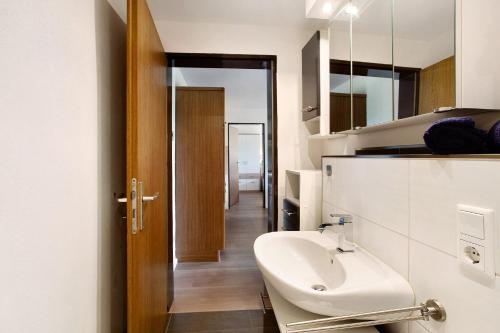 a bathroom with a sink and a mirror at Ruhrtalblick in Bestwig