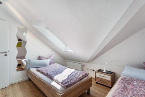 a bedroom with two beds in a attic at Haus Schönblick - "Fewo Sarina 2" in Willingen