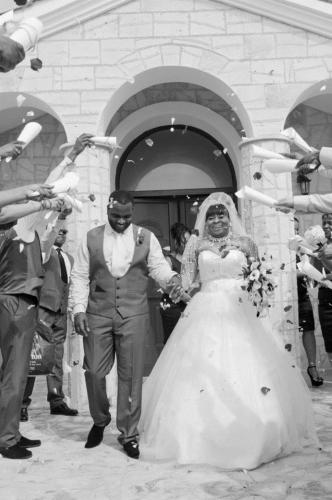 a bride and groom walking down the aisle at Club St. George in Paphos City