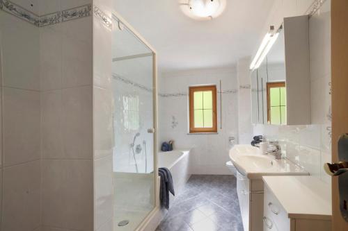 a bathroom with a shower and a tub and a sink at Hienerhof in Moso
