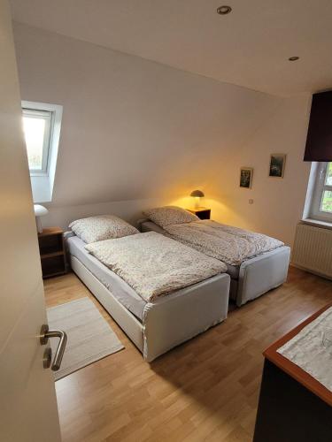 a bedroom with two beds and a window at Kiepe im Münsterland in Nordwalde