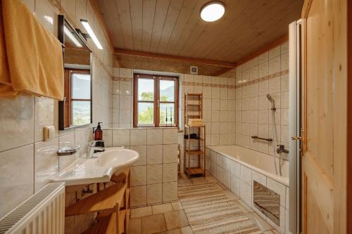 a bathroom with a sink and a tub at Chalet Hinterweiding Gut in Wiederriesen