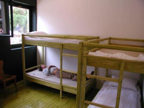 A bed or beds in a room at Hullam Hostel