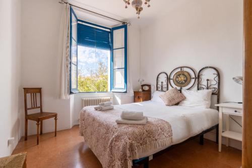 a bedroom with a large bed and a window at Masia Sant Miquel in Canet de Mar