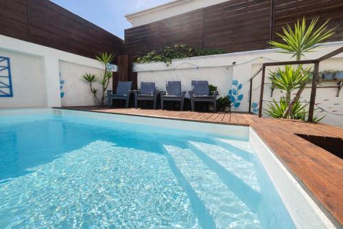 a swimming pool with blue water in a house at Boreal Porto Gaia - Patio & Pool in Vila Nova de Gaia