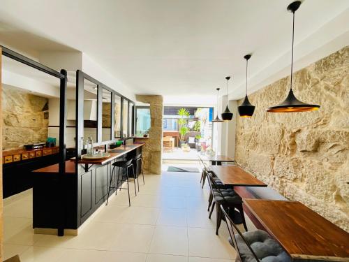 an open kitchen with wooden tables and benches at Boreal Porto Gaia - Patio & Pool in Vila Nova de Gaia