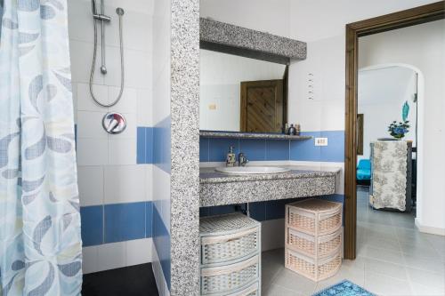 a bathroom with a sink and a shower at Azzurra in Orosei