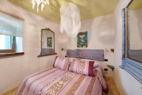 a bedroom with a bed and a mirror at Casa Gocce Di Cristallo in Varazze