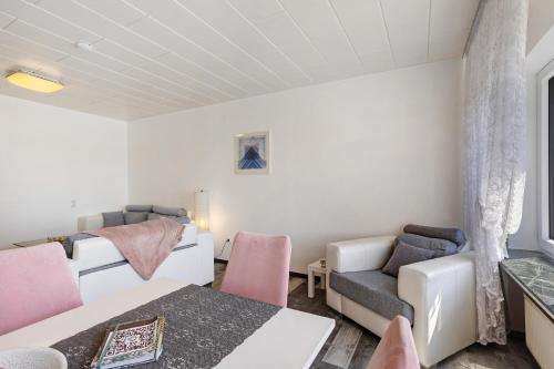 a living room with a bed and a couch at Ferienwohnung Cakir in Meinerzhagen