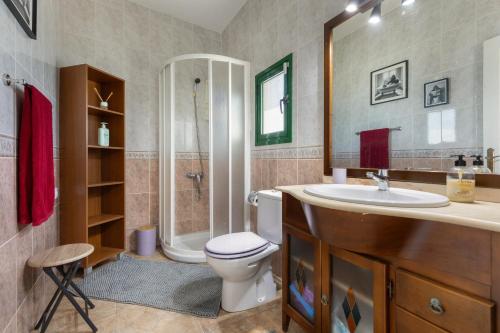 a bathroom with a toilet and a sink and a shower at Buganvilla in Pájara