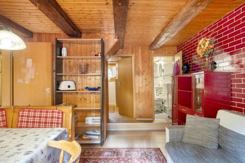 a living room with a red brick wall at Haus Antonis in Triberg