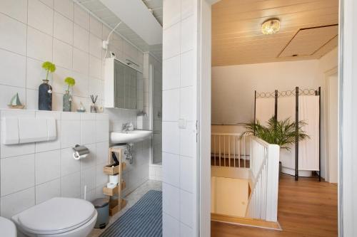 a bathroom with a toilet and a sink at Ferienhaus Frieda in Röfingen