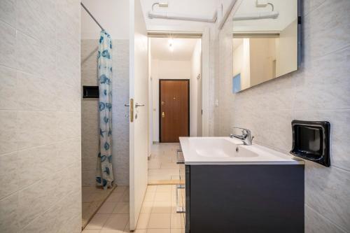 a bathroom with a sink and a mirror at Appartamento Andromeda B4 in Bibione