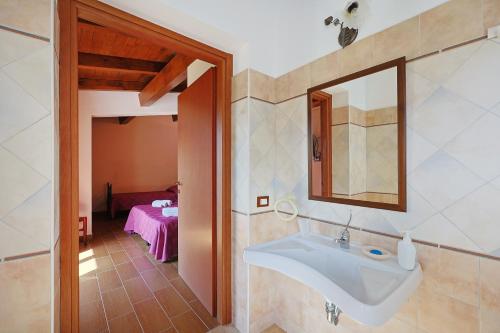 a bathroom with a sink and a mirror at Bed And Breakfast Sciarammola in Patti